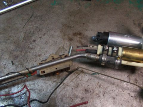 1988 Ford C-350 (Centurion Conversions) - A disassembled fuel pump assembly with associated wiring and hoses is shown on a work surface.