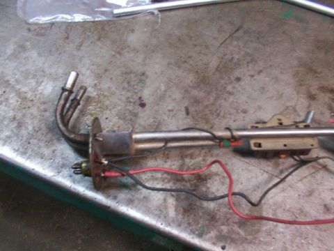 1988 Ford C-350 (Centurion Conversions) - A fuel pump sender unit with attached wiring and metal tubes is shown on a textured surface.