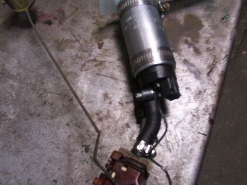 1988 Ford C-350 (Centurion Conversions) - A fuel pump assembly, likely for a vehicle, is shown on a workbench surface.