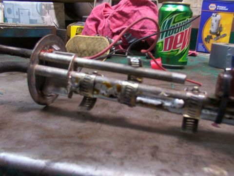 1988 Ford C-350 (Centurion Conversions) - Close-up of a fuel pump assembly with visible wiring and metal components on a workbench.