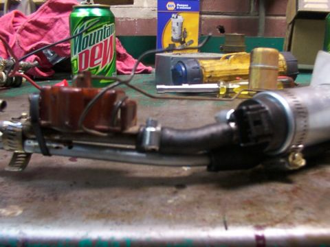 1988 Ford C-350 (Centurion Conversions) - A fuel pump assembly is shown on a workbench, with a can of Mountain Dew and NAPA parts box in the background.