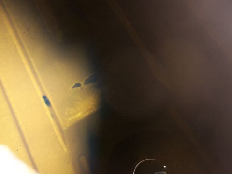 1988 Ford C-350 (Centurion Conversions) - A close-up view of a dark metal component, showing signs of corrosion and blue staining.