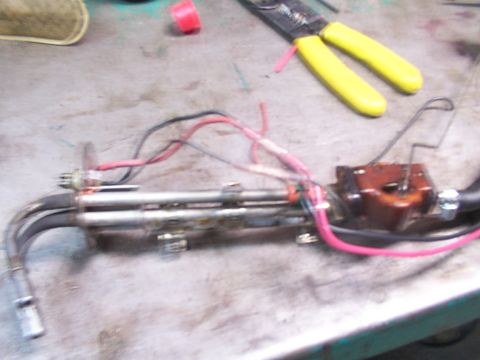 1988 Ford C-350 (Centurion Conversions) - Fuel pump assembly with wiring and tools on a workbench. The claim of a 1988 Ford C-350 is not supported by the image.
