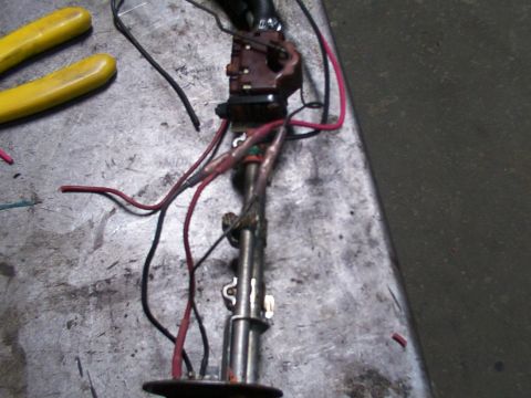 1988 Ford C-350 (Centurion Conversions) - A disassembled fuel pump assembly with exposed wiring and connectors sits on a workbench.
