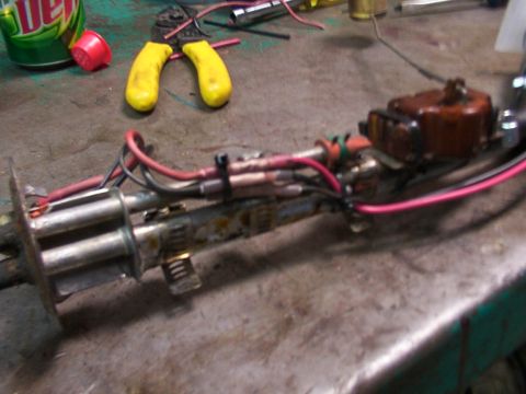1988 Ford C-350 (Centurion Conversions) - A close-up of a vehicle's fuel pump assembly, showing wiring and connectors, with tools nearby.