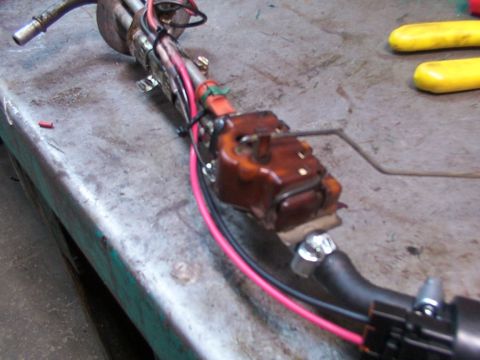 1988 Ford C-350 (Centurion Conversions) - A disassembled fuel pump assembly is shown on a metal surface, with wiring and a float arm visible.