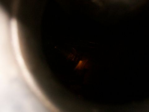 1988 Ford C-350 (Centurion Conversions) - The image shows a dark, out-of-focus interior with a faint orange light reflection.