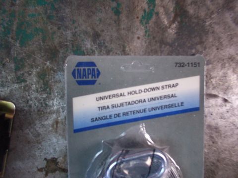 1988 Ford C-350 (Centurion Conversions) - The packaging for a NAPA Universal Hold-Down Strap is shown, with no vehicle visible.