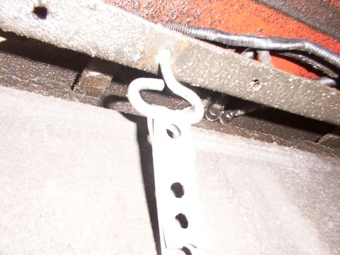 1988 Ford C-350 (Centurion Conversions) - This is a close-up view of a metal bracket, likely for a fuel tank strap, attached to a vehicle's frame.