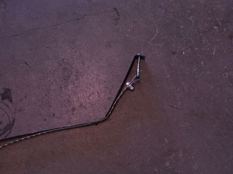 1988 Ford C-350 (Centurion Conversions) - A single fuel tank strap bracket is shown mounted to a bolt on a concrete floor.
