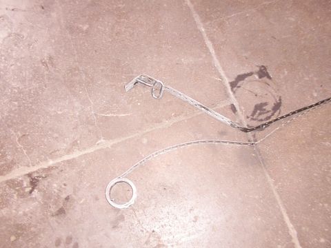 1988 Ford C-350 (Centurion Conversions) - Two metal fuel tank straps are shown lying on a concrete floor.