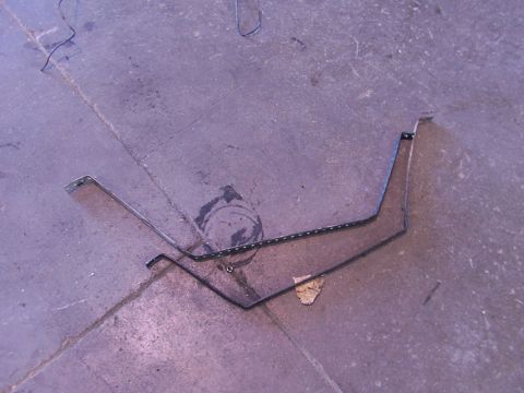 1988 Ford C-350 (Centurion Conversions) - These are fuel tank straps, likely removed from a vehicle for replacement or repair.