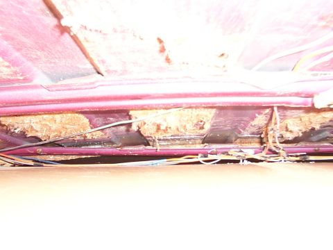 1988 Ford C-350 (Centurion Conversions) - Exposed wiring and damaged insulation beneath a vehicle's headliner.