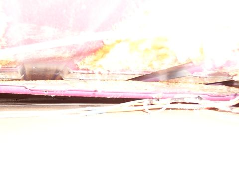1988 Ford C-350 (Centurion Conversions) - Damage to the vehicle's interior headliner reveals exposed insulation and wiring, indicating a need for repair.