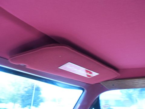 1988 Ford C-350 (Centurion Conversions) - Interior view of a vehicle's headliner and sun visor with a 'Thank you for your business' sticker.