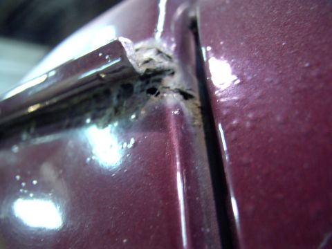 1988 Ford C-350 (Centurion Conversions) - Close-up of significant rust damage on the drip rail area of a vehicle.