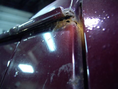 1988 Ford C-350 (Centurion Conversions) - Rust damage is visible under the drip rail of a vehicle's body panel.