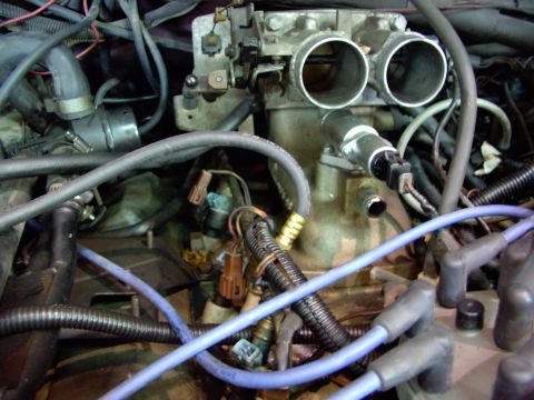 1988 Ford C-350 (Centurion Conversions) - A close-up view of engine components, focusing on the throttle body and fuel injectors.