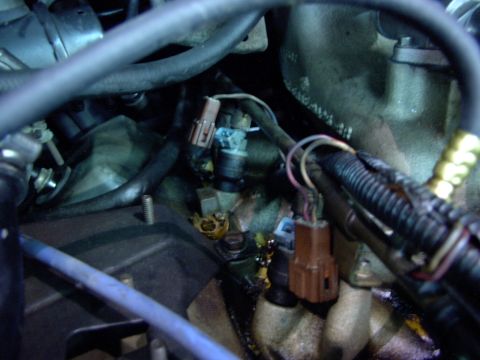 1988 Ford C-350 (Centurion Conversions) - Close-up view of engine injectors and associated wiring, showing mechanical components.