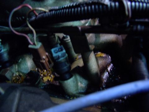 1988 Ford C-350 (Centurion Conversions) - Fuel injectors with visible wiring and connectors, likely from an engine bay.