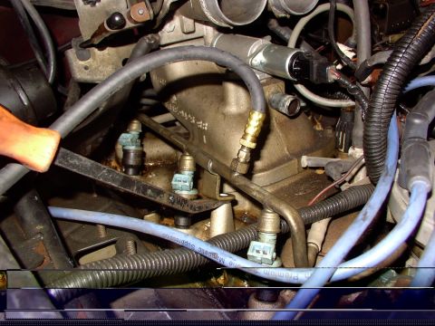 1988 Ford C-350 (Centurion Conversions) - Close-up view of engine injectors and fuel rail, showing mechanical and electrical connections.