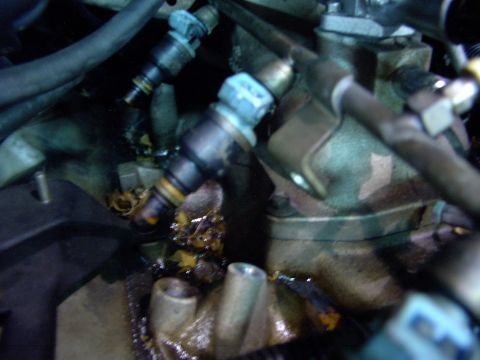 1988 Ford C-350 (Centurion Conversions) - Close-up view of engine fuel injectors, showing their connections and surrounding mechanical parts.