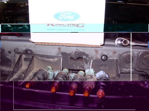 1988 Ford C-350 (Centurion Conversions) - Fuel injectors are visible below a box labeled Ford Racing Performance Parts.