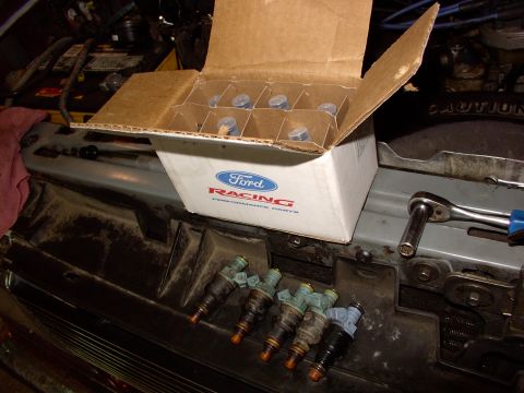 1988 Ford C-350 (Centurion Conversions) - Ford Racing parts box and fuel injectors laid out near engine components.