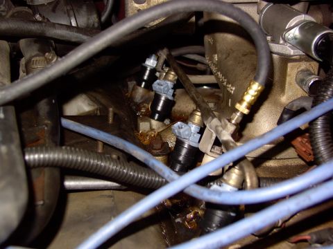1988 Ford C-350 (Centurion Conversions) - Close-up view of multiple fuel injectors and associated engine components.
