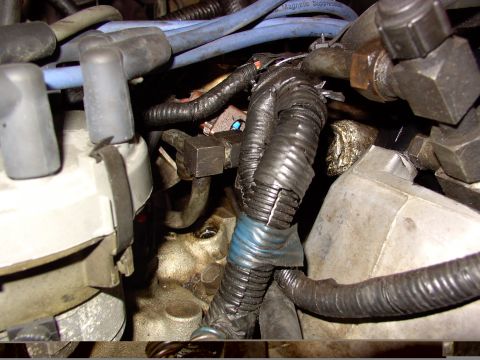 1988 Ford C-350 (Centurion Conversions) - Close-up view of engine components, focusing on the wiring and fuel delivery system.