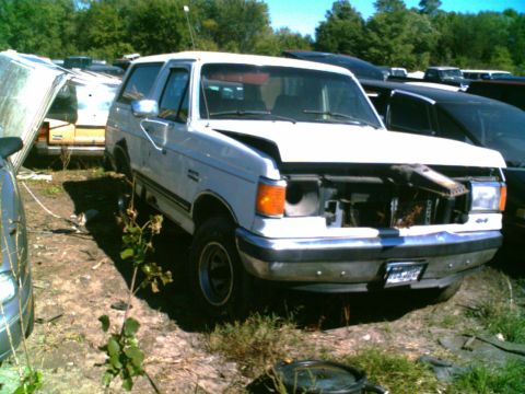 1988 Ford C-350 (Centurion Conversions) - Junkyard Bronco, likely a 1987 model, with front end damaged and hood up.