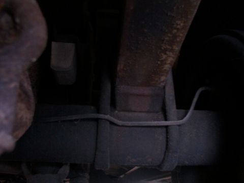 1988 Ford C-350 (Centurion Conversions) - Underside view of a rear suspension lift block, a modification often seen on trucks.