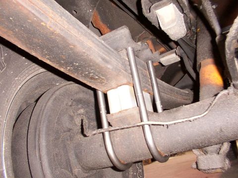 1988 Ford C-350 (Centurion Conversions) - Close-up view of the rear suspension components, including leaf springs and lift blocks.