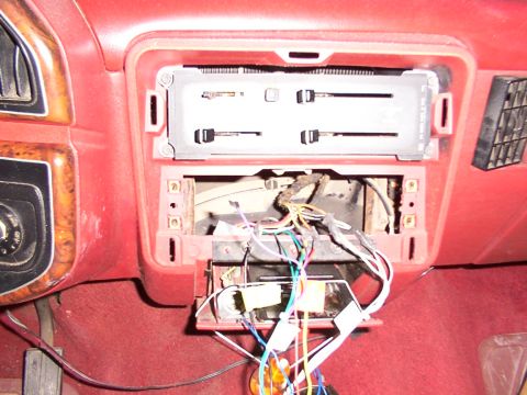 1988 Ford C-350 (Centurion Conversions) - The dashboard of a vehicle shows exposed wiring and components after the radio has been removed.