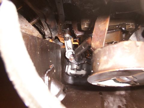 1988 Ford C-350 (Centurion Conversions) - Close-up view of an engine's oil pump and associated plumbing, showing mechanical components.