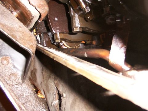 1988 Ford C-350 (Centurion Conversions) - Engine crankshaft and connecting rod bearings are visible in this close-up view, covered in oil.