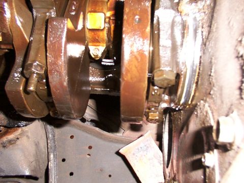 1988 Ford C-350 (Centurion Conversions) - This image shows the internal components of an engine, specifically the crankshaft and connecting rods, covered in oil.