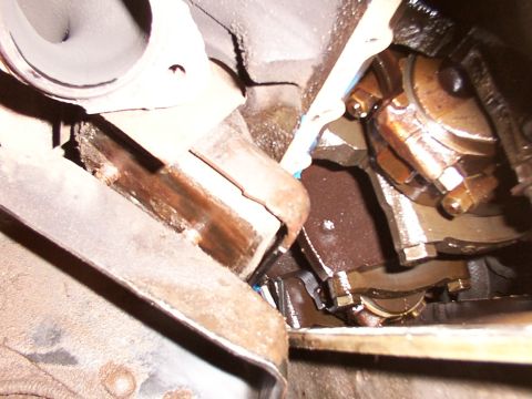 1988 Ford C-350 (Centurion Conversions) - Close-up view of engine crankshaft and bearing assembly, indicating potential wear or damage.