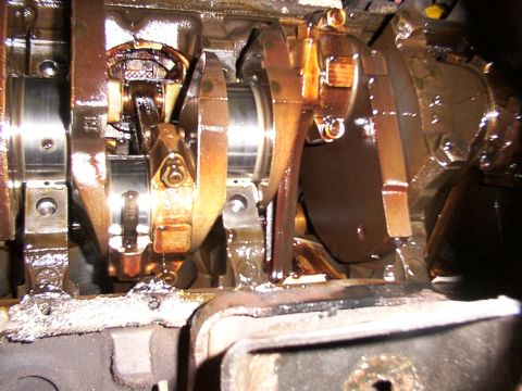 1988 Ford C-350 (Centurion Conversions) - Engine crankshaft and connecting rods, likely showing wear or damage.