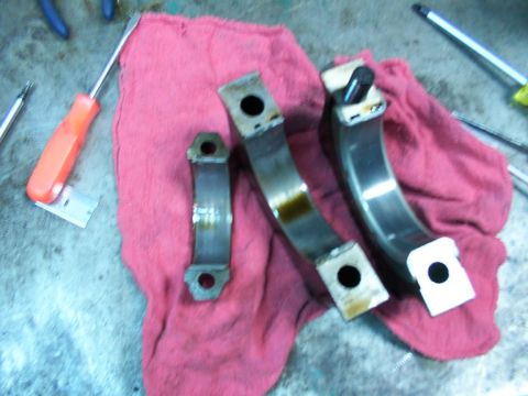 1988 Ford C-350 (Centurion Conversions) - Several engine bearing parts are laid out on a red shop towel next to screwdrivers.