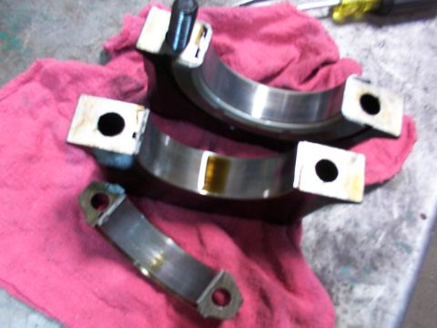 1988 Ford C-350 (Centurion Conversions) - Engine bearing caps are shown on a red cloth, likely for repair or inspection.