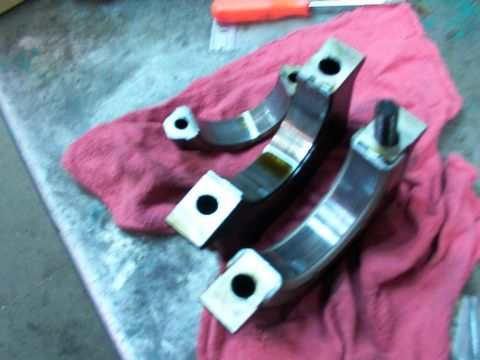 1988 Ford C-350 (Centurion Conversions) - Several engine bearing caps are laid out on a red cloth, possibly for inspection or replacement.