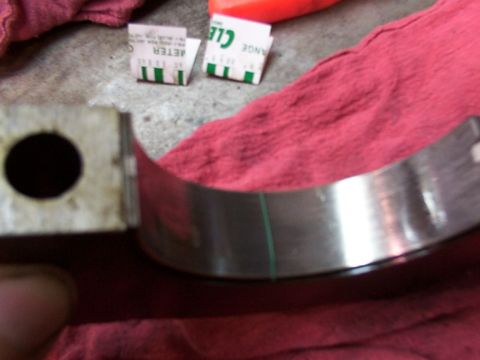 1988 Ford C-350 (Centurion Conversions) - A close-up view of an engine bearing, marked with a green line and accompanied by measurement tabs.