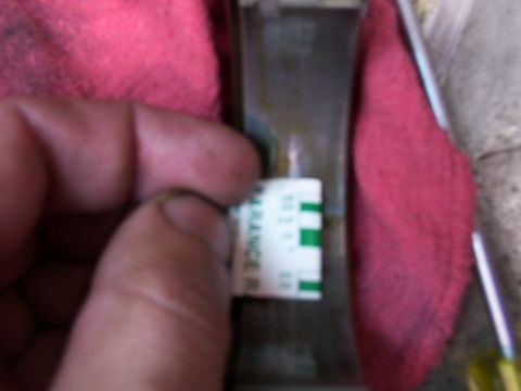 1988 Ford C-350 (Centurion Conversions) - A mechanic uses a clearance gauge on a part, with green marks indicating acceptable tolerance.