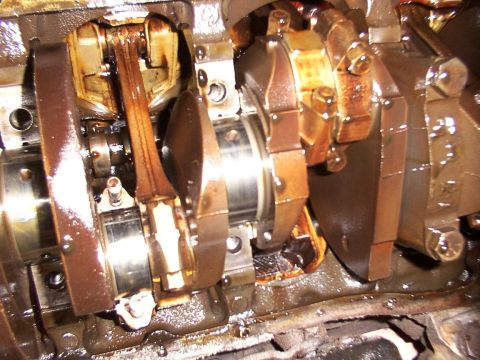 1988 Ford C-350 (Centurion Conversions) - Engine crankshaft and connecting rods with bearing caps, showing internal engine components.