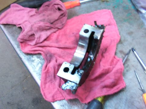 1988 Ford C-350 (Centurion Conversions) - A heavily damaged engine bearing rests on a pink shop rag, indicating a significant mechanical failure.