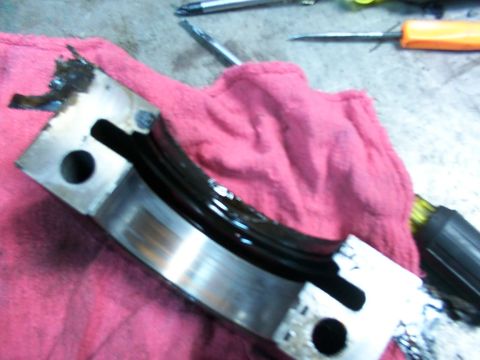 1988 Ford C-350 (Centurion Conversions) - Engine bearing showing wear and oil residue, likely from a rear main seal repair.
