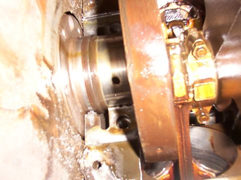 1988 Ford C-350 (Centurion Conversions) - Close-up view of an engine's crankshaft and connecting rod, showing oil and potential wear.