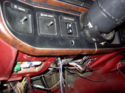 1988 Ford C-350 (Centurion Conversions) - Exposed wiring and dashboard switches, including one labeled "Rear Window", are visible in the vehicle's interior.