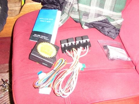 1988 Ford C-350 (Centurion Conversions) - Remote start system components laid out on a red surface, with an installation manual visible.